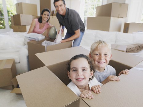 Professional movers carrying items down stairs during a Croydon flat removal