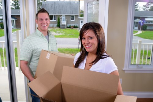 Removal team loading boxes and furniture into a moving van