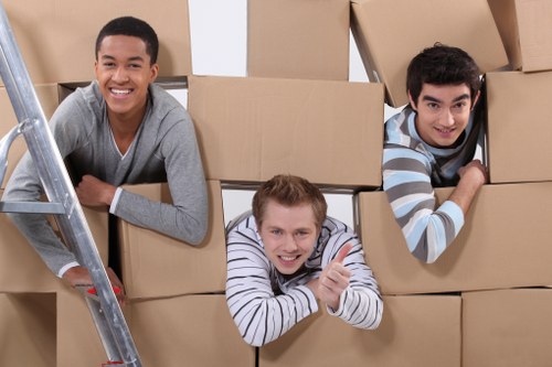 Trained removal staff carrying furniture with protective gear