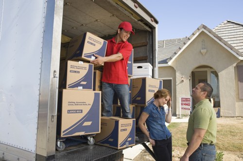 Local moving team handling household furniture and boxes