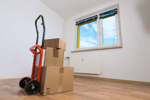 Movers protecting floors and door frames during a house move